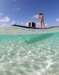 Beautiful woman fishing from paddle board