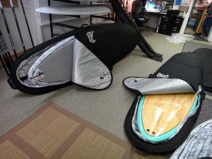 A picture of two stand up paddle boards in bags