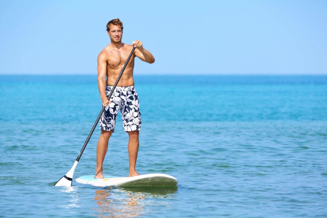 Man SUP Boarding on the ocean