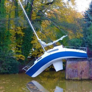 We have no idea how the sailbot ended on the wrong side of the river. It seems like the owner could have been drunk, consequently creating a new dock for the poor boat.