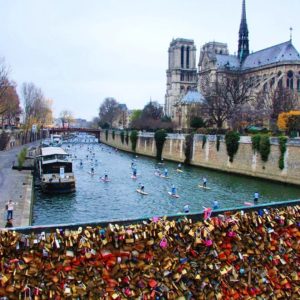 love locks and paddleboards take center stage in Paris, another perfect photo for SUP enthusiasts.