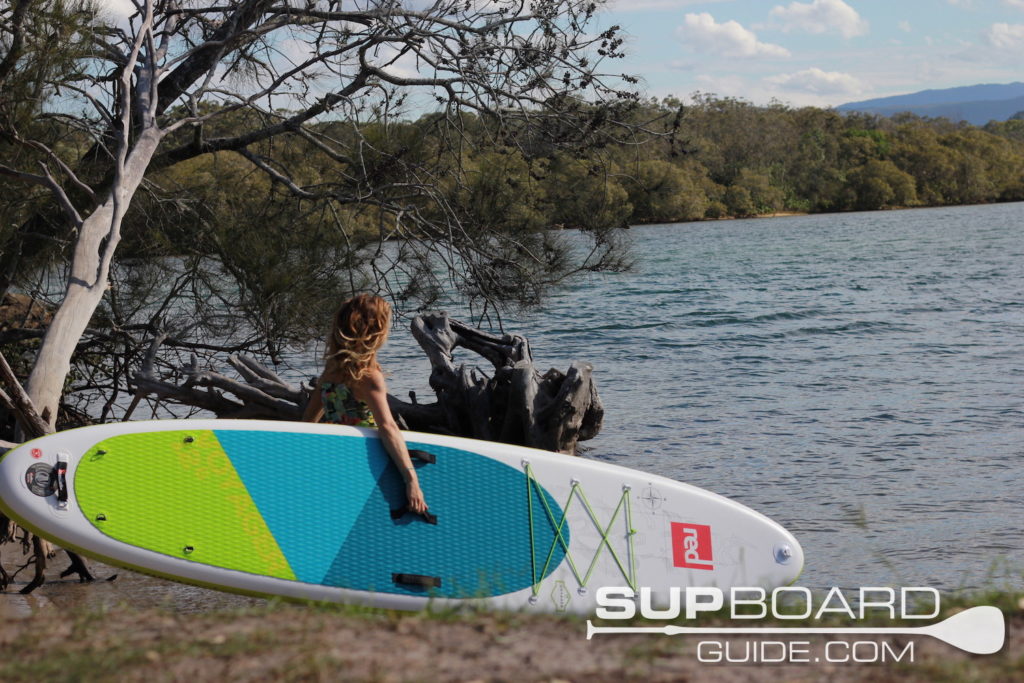 Carrying SUP into river